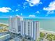 Stunning exterior view of a high-rise condo building with ocean views and meticulously landscaped grounds at 504 N Ocean Blvd. # 310, Myrtle Beach, SC 29577