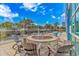Outdoor fire pit with lounge seating and surrounding tropical landscaping on a sunny day at 504 N Ocean Blvd. # 310, Myrtle Beach, SC 29577