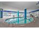 Indoor pool with blue support beams and walls, along with lounge chairs behind windows at 504 N Ocean Blvd. # 310, Myrtle Beach, SC 29577