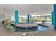 Indoor pool with blue columns, tropical plants visible behind windows, and stone tile flooring at 504 N Ocean Blvd. # 310, Myrtle Beach, SC 29577