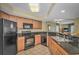 Well-equipped kitchen with stainless steel appliances, granite countertops, and wooden cabinets at 504 N Ocean Blvd. # 310, Myrtle Beach, SC 29577