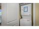 Stackable washer and dryer inside a laundry closet, next to white door in condo at 504 N Ocean Blvd. # 310, Myrtle Beach, SC 29577
