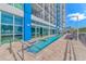 Outdoor pool next to condo building with stairs leading into the water and lounge chairs at 504 N Ocean Blvd. # 310, Myrtle Beach, SC 29577