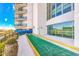 Outdoor recreational area with shuffle board, blue railing and tropical plants on sunny day at 504 N Ocean Blvd. # 310, Myrtle Beach, SC 29577