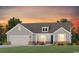 Charming single-Gathering home featuring a gray exterior, brick accents, and a well-manicured lawn at sunset at 523 Oak Landing Dr., Myrtle Beach, SC 29588