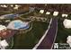 Aerial view of community pool, tennis courts, lake, and clubhouse surrounded by lush landscaping at 523 Oak Landing Dr., Myrtle Beach, SC 29588