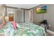 Cozy bedroom features a vibrant leaf comforter, TV, and ensuite bathroom access at 5511 N Ocean Blvd. # 202, Myrtle Beach, SC 29577
