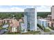 Stunning exterior view of condo building with pools, lush greenery, and beautiful landscaping at 5511 N Ocean Blvd. # 202, Myrtle Beach, SC 29577