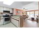 Efficient kitchen with stainless steel appliances, granite countertops, and a breakfast bar at 5511 N Ocean Blvd. # 202, Myrtle Beach, SC 29577