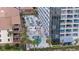Aerial view showcasing multiple pools and a towering beachfront condo at 5511 N Ocean Blvd. # 202, Myrtle Beach, SC 29577