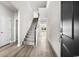 Welcoming foyer with hardwood floors, a staircase, and natural light streaming in from the windows at 555 Cypress Preserve Circle, Longs, SC 29568