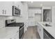 Modern kitchen with stainless steel appliances, white cabinetry, and a center island with a sink at 555 Cypress Preserve Circle, Longs, SC 29568