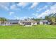 Expansive backyard featuring a screened porch, lush lawn, and surrounding trees at 556 Timber Creek Dr., Loris, SC 29569