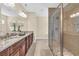 Beautiful bathroom featuring double sinks, granite countertops, and a spacious glass enclosed shower at 556 Timber Creek Dr., Loris, SC 29569