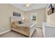 Neutral bedroom featuring a ceiling fan, plush carpet, and a large window for natural light at 556 Timber Creek Dr., Loris, SC 29569