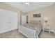 Neutral bedroom with a ceiling fan, double doors, and a large window for natural light at 556 Timber Creek Dr., Loris, SC 29569