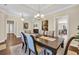 Elegant dining room with modern chandelier, hardwood flooring, and stylish decor, perfect for hosting gatherings at 556 Timber Creek Dr., Loris, SC 29569