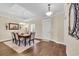 Dining area with tray ceiling, wood floors, chandelier, and a view of the front entry at 556 Timber Creek Dr., Loris, SC 29569