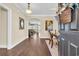 Inviting home foyer with hardwood floors, archway, and decorative mirror, providing a warm welcome at 556 Timber Creek Dr., Loris, SC 29569