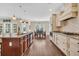 Bright kitchen with granite counters, an island with seating, and view of adjacent dining area at 556 Timber Creek Dr., Loris, SC 29569