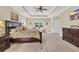 Bright main bedroom suite with tray ceilings, plush carpeting, and plenty of natural light at 556 Timber Creek Dr., Loris, SC 29569