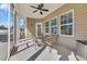 Cozy screened porch with comfortable seating, ceiling fan, and ample natural light at 556 Timber Creek Dr., Loris, SC 29569