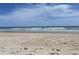 Relax on the sandy beach with the ocean breeze, under blue skies and light clouds at 5601 N Ocean Blvd. # E-111, Myrtle Beach, SC 29577