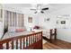 Bright bedroom featuring two beds, coastal-themed decor, and a ceiling fan at 5601 N Ocean Blvd. # E-111, Myrtle Beach, SC 29577
