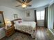 Comfortable bedroom with a queen-sized bed, floral bedding, and wood-look laminate flooring at 5601 N Ocean Blvd. # E-111, Myrtle Beach, SC 29577