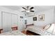 Bright bedroom featuring two beds, coastal-themed decor, and a ceiling fan at 5601 N Ocean Blvd. # E-111, Myrtle Beach, SC 29577