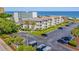 Aerial view of condos with a parking lot and ocean views, situated near the beach at 5601 N Ocean Blvd. # E-111, Myrtle Beach, SC 29577