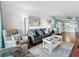 Cozy living room showcasing a comfortable sofa and a coastal-themed rug, adjacent to an open kitchen at 5601 N Ocean Blvd. # E-111, Myrtle Beach, SC 29577