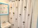 The bathroom features a palm tree shower curtain, sink, and mirror at 6001-1843 S Kings Highway, Myrtle Beach, SC 29575