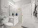 Well-lit bathroom with white vanity, toilet, mirror, and coastal decor at 601 Hillside Dr. # 4233, North Myrtle Beach, SC 29582