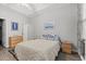 Relaxing bedroom featuring wood floors, tray ceiling, and comfy queen bed at 601 Hillside Dr. # 4233, North Myrtle Beach, SC 29582