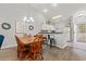 Bright dining area with a wooden table and chairs, flowing into the kitchen with modern appliances at 601 Hillside Dr. # 4233, North Myrtle Beach, SC 29582