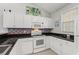 Bright kitchen with stainless steel appliances, white cabinetry and colorful tile backsplash at 601 Hillside Dr. # 4233, North Myrtle Beach, SC 29582