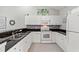 Well-lit kitchen features white cabinets and stainless steel sink and appliances at 601 Hillside Dr. # 4233, North Myrtle Beach, SC 29582
