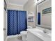 Nautical-themed bathroom featuring vanity, nautical decor, commode, framed mirror, and shower with anchor curtain at 601 Hillside Dr. N # 3031, North Myrtle Beach, SC 29582