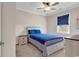 Neutrally decorated bedroom with white furniture, blue bedding, and dark blue window shade at 601 Hillside Dr. N # 3031, North Myrtle Beach, SC 29582