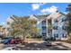 Multi-story building with tan siding, white trim, patios and mature landscaping at 601 Hillside Dr. N # 3031, North Myrtle Beach, SC 29582
