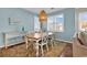 Charming dining room with a wooden table, light blue walls, and natural light at 601 Hillside Dr. N # 3031, North Myrtle Beach, SC 29582