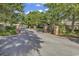 A wide shot of the community's entrance gate shows brick columns, and a security arm at 601 Hillside Dr. N # 3031, North Myrtle Beach, SC 29582