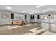 A spacious game room is showcased, featuring a pool table, ping pong table, and plenty of natural light at 601 Hillside Dr. N # 3031, North Myrtle Beach, SC 29582