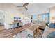 Comfortable living space featuring wood floors, modern ceiling fan, television, and stylish furnishings at 601 Hillside Dr. N # 3031, North Myrtle Beach, SC 29582