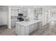 Modern kitchen with an island and stainless steel appliances, adjacent to additional living spaces at 619 Castle Ct., Myrtle Beach, SC 29579