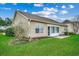 Exterior home view featuring a well-maintained backyard and screened patio at 645 Twinflower St., Little River, SC 29566