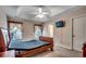 Bedroom with tray ceilings, ceiling fan, bedside tables, and mounted television at 645 Twinflower St., Little River, SC 29566