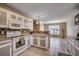 Bright kitchen featuring white cabinets, granite countertops, mosaic backsplash, and modern appliances at 645 Twinflower St., Little River, SC 29566
