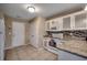 Bright kitchen featuring white cabinetry, granite countertops, and a mosaic backsplash at 645 Twinflower St., Little River, SC 29566